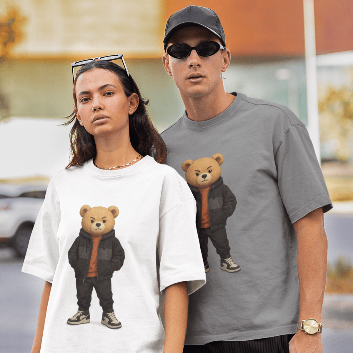Two people wearing t-shirts with bear graphics in an urban setting.